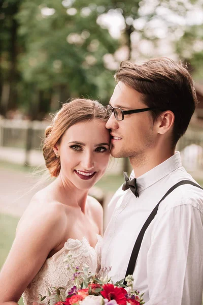 Portrait of happy newlyweds on blurred background. — Stock Photo, Image