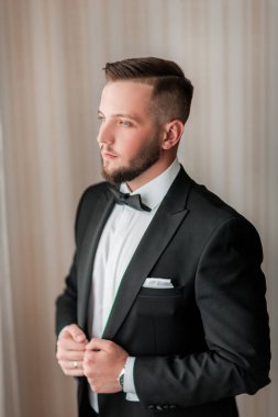 Kapat. Ceketini ilikleyen ciddi bir adam..