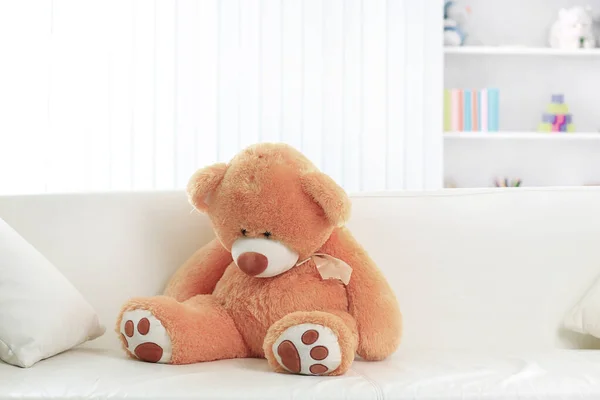 Toy bear on the couch in the nursery — Stock Photo, Image