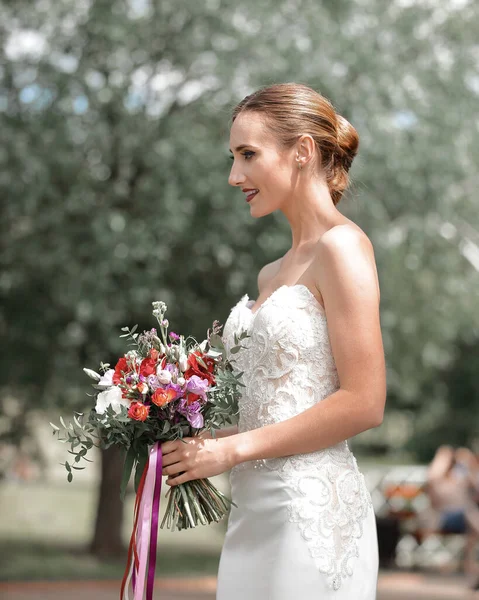 サイドビュー。結婚式の花束を持つ幸せな花嫁. — ストック写真