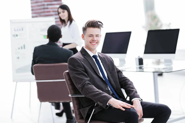 Portrait of young employees sitting near the desktop — Stock Photo, Image