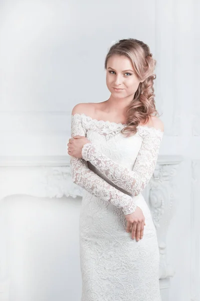 Smiling happy bride trying on wedding dress — Stock Photo, Image