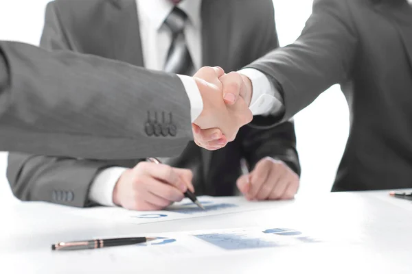 Close up.handshake of financial partners after signing the contract — Stock Photo, Image