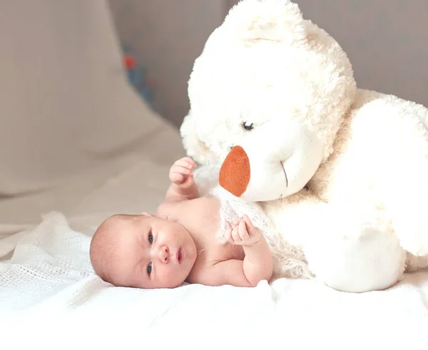 Bonita niña recién nacida con un gran juguete suave acostado en la manta . — Foto de Stock