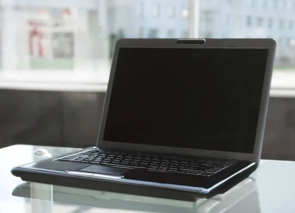 Open laptop on glass table in modern office — Stock Photo, Image