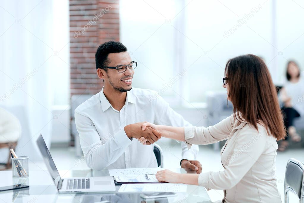 businessman and businesswoman making a deal in a modern office
