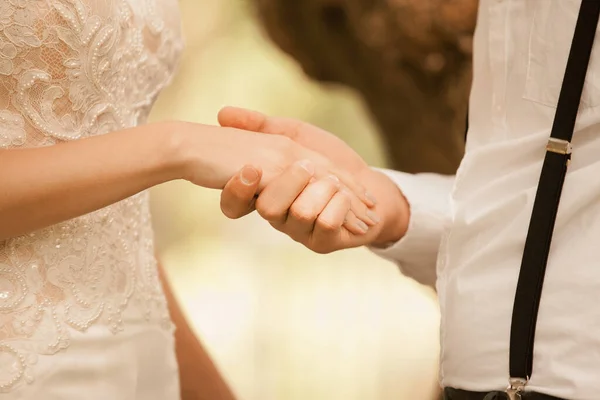 Close up.the happy groom holds his brides hand — Stock Photo, Image