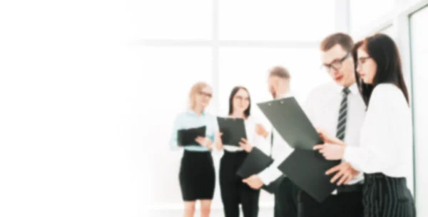 Group of business people discussing documents for a new business project. background for text in blur with copy space — Stock Photo, Image