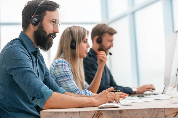 close up. call center operators work in a modern office.