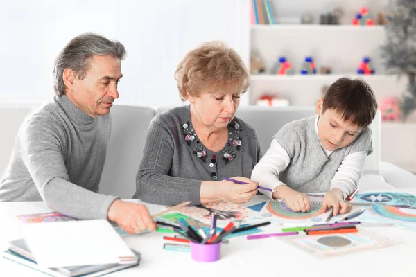 Little boy painting with grandpa and grandma. concept of education — Stock Photo, Image