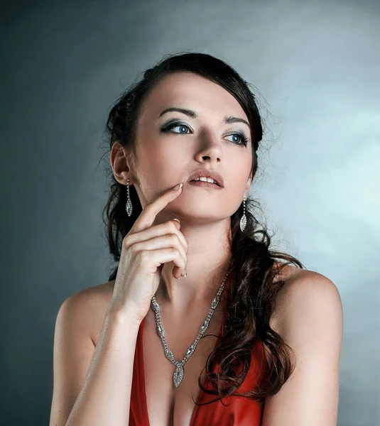 Ambitious beautiful woman in a red dress.isolated on dark — Stock Photo, Image