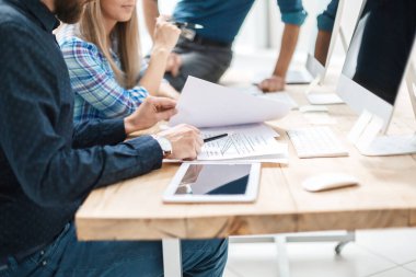 İş ekibi yeni proje için belgeleri tartışıyor