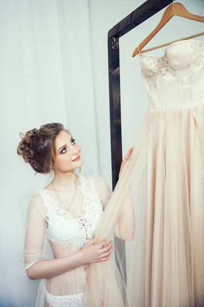 Happy girl trying on her wedding dress — Stock Photo, Image