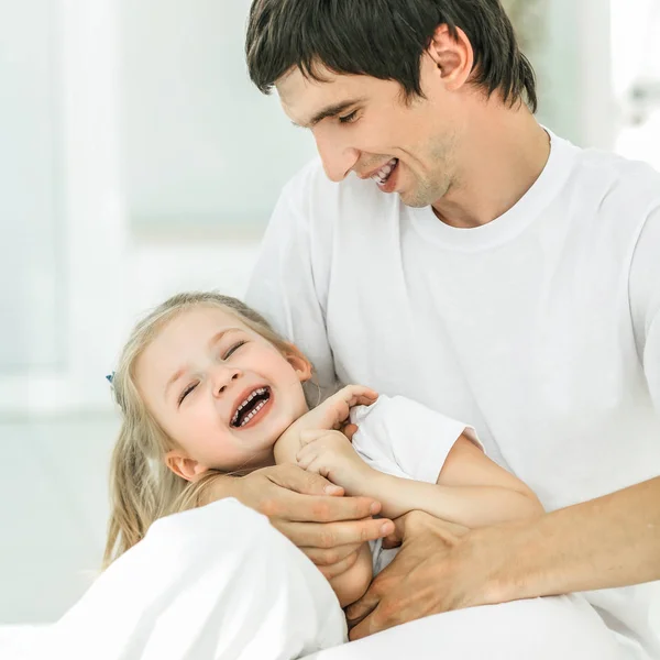 Dad and his daughter child girl are playing, smiling and huggin — Stok fotoğraf