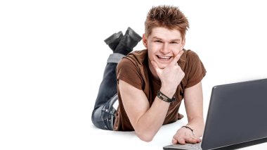 portre. modern adam yerde yatarken laptop çalışma.