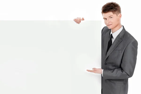 Exitoso joven hombre de negocios mirando banner en blanco —  Fotos de Stock