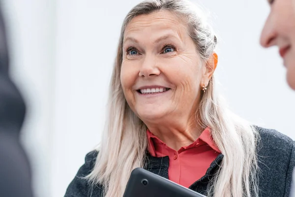 close up. smiling businesswoman talking to her colleagues