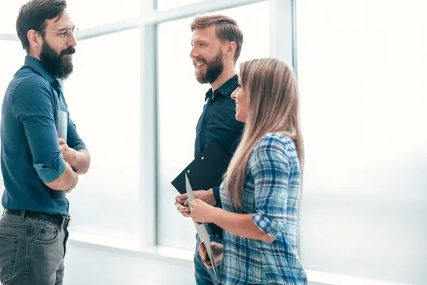 Group of business people discussing something in the office corridor — 스톡 사진