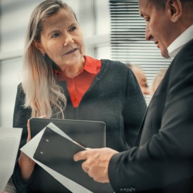business people discuss documents standing in the office
