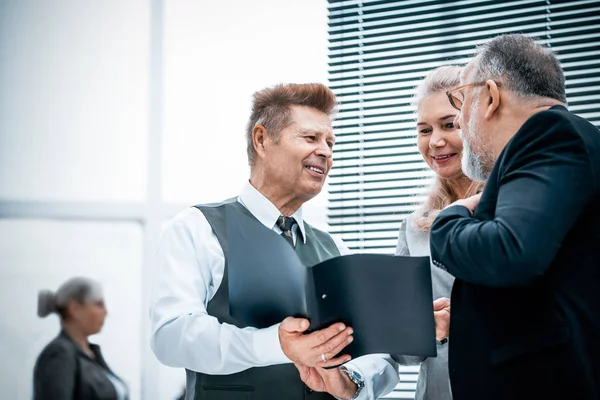 close up. experienced company employees discussing business documents