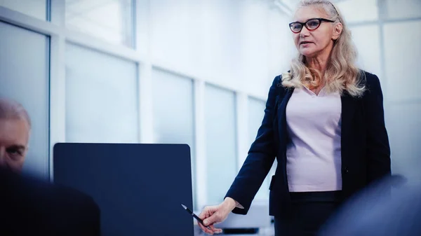 businesswoman makes a report at a meeting in the office