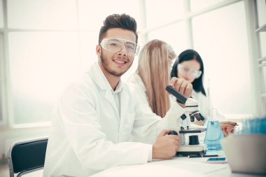 young scientist and his assistants testing a coronavirus vaccine