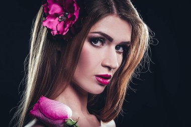 Uzun düz saçları ve elinde bir gülle göz alıcı bir kız..