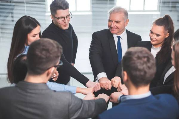 close up. a team of young professionals standing in a circle