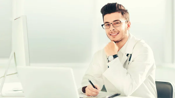 Läkare terapeut sitter vid ett bord på sitt kontor — Stockfoto