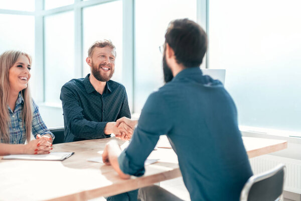 Manager shaking hands with the applicant during the interview
