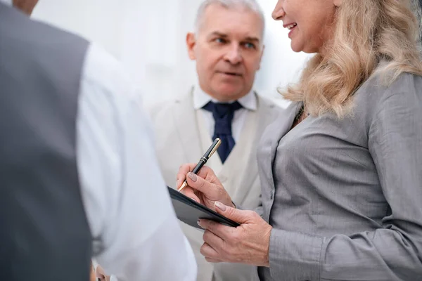 Close up. group of serious business people standing near the office window — Stok fotoğraf