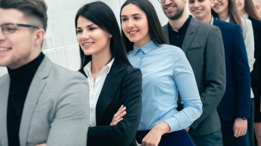 successful businessman standing ahead of his business team