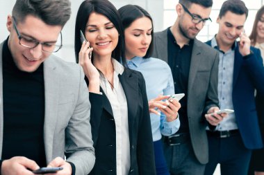 group of diverse young people use their smartphones