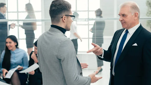 Serious boss explaining something to his assistant — Stock Photo, Image