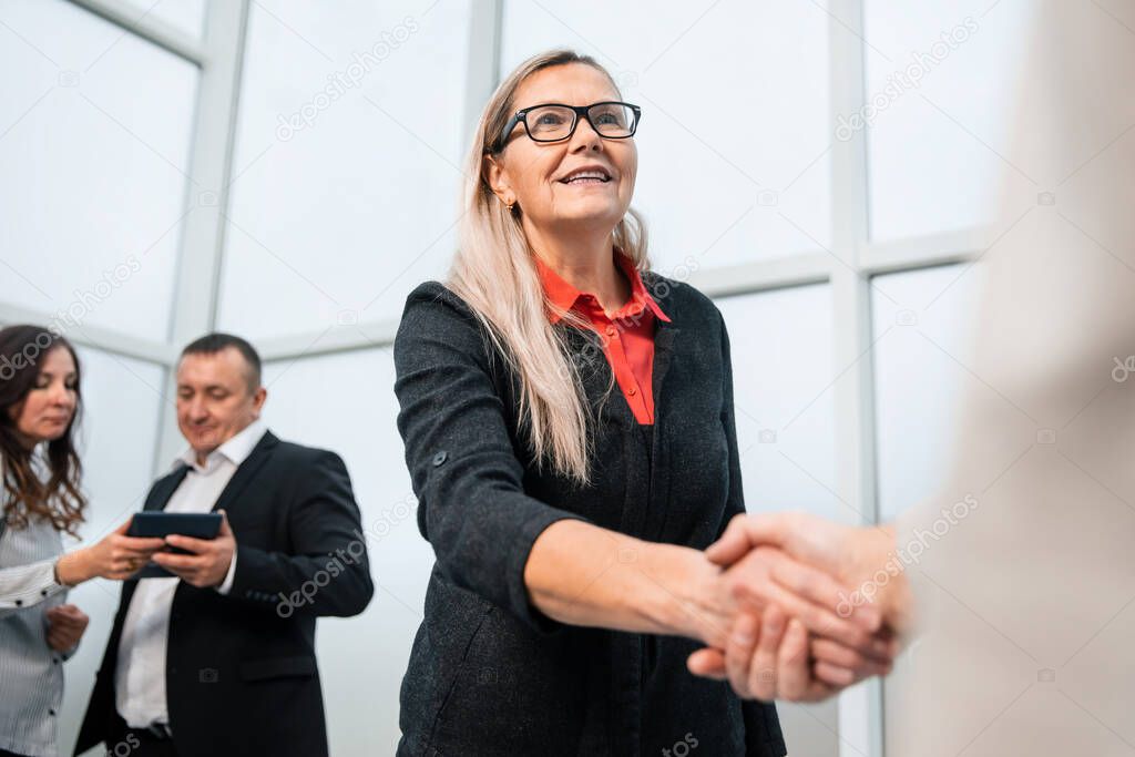 close up. confident business people shaking hands with each other