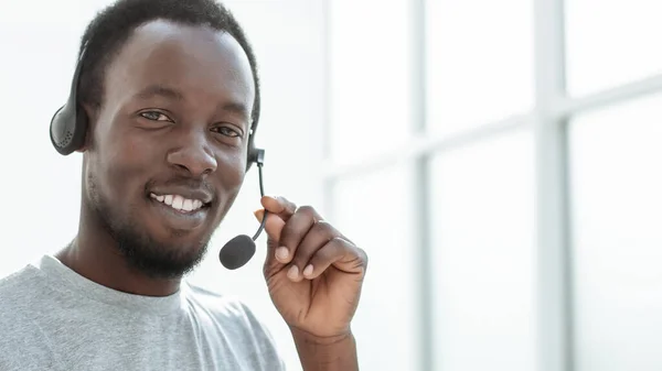 Close up. a handsome young man with a headset. — Stock Photo, Image