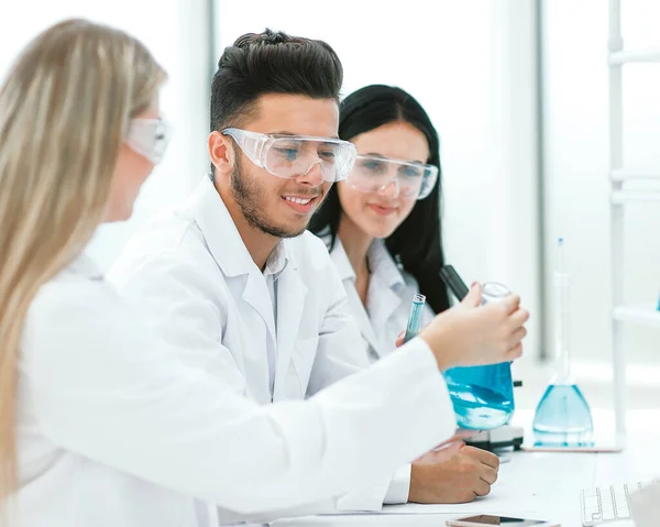 Close up.a team of scientists sitting at the laboratory table — Stock Photo, Image