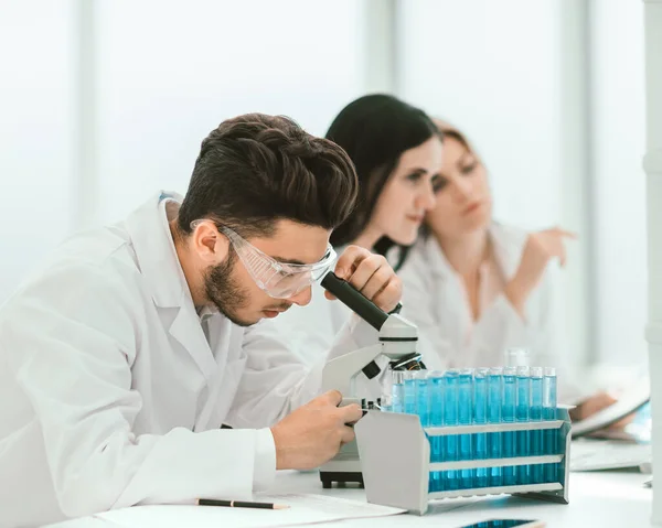 stock image close up.man scientist looking through a microscope
