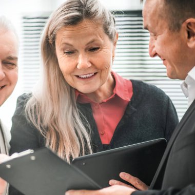 Proje Yöneticisi çalışma belgelerini meslektaşlarıyla tartışıyor