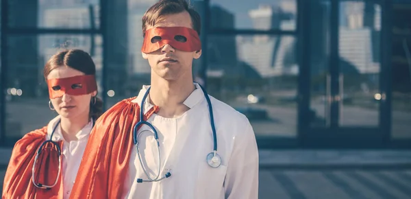 close up. doctors are superheroes standing on a city street .