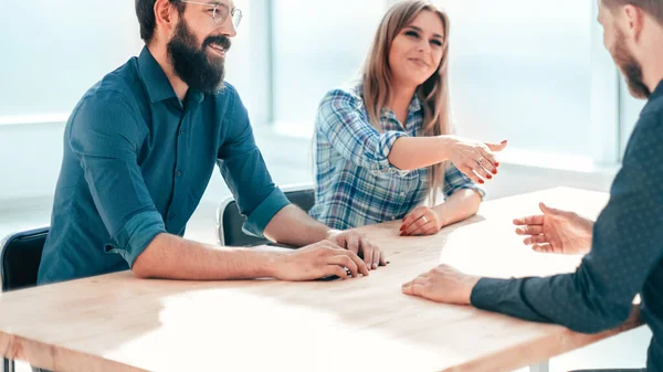 Young businesswoman reaching out for a handshake during an interview — Stock Photo, Image