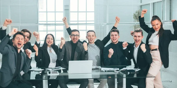 large business team showing their success while sitting at their Desk
