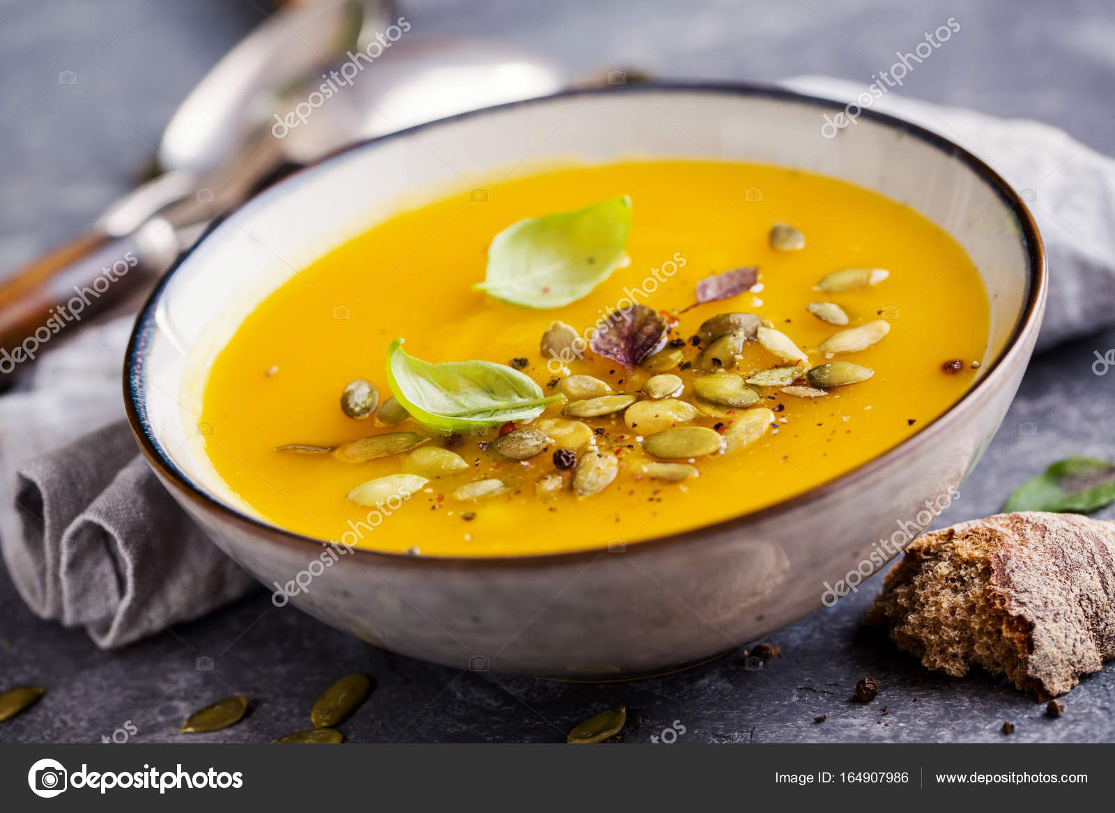 Pumpkin soup with basil leaf — Stock Photo © Vell 164907986