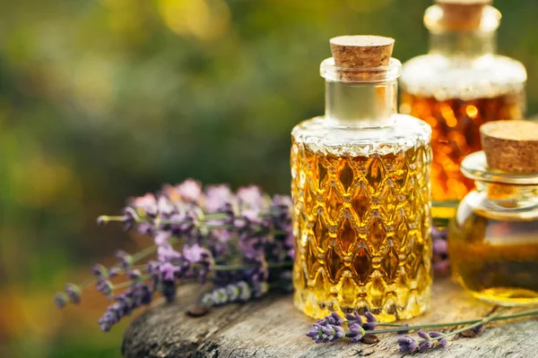 Lavender oil in bottles and fresh lavender.