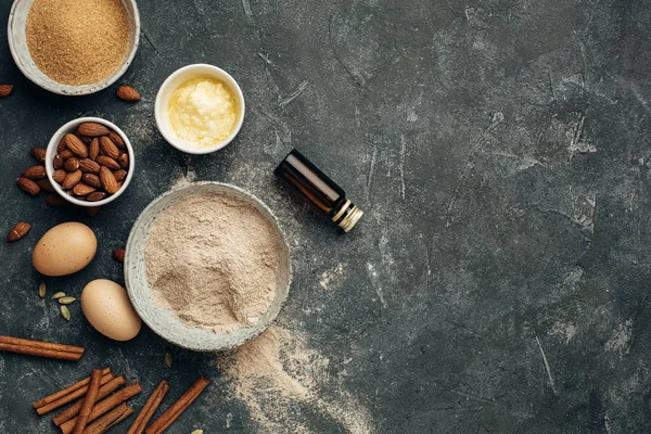 Ingredients for baking, almond flour, butter, sugar, eggs and spices.