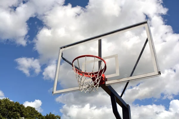 Basketball backboard on blue cloudy sky background — Stock Photo, Image