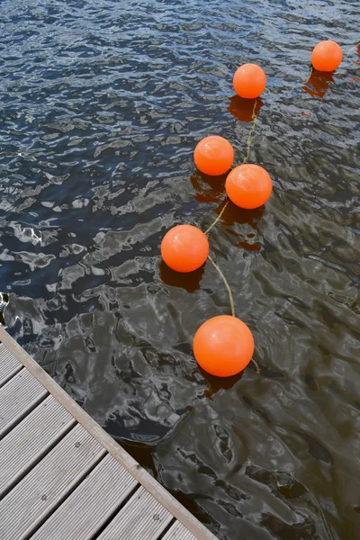 Orange buoy group on lake water — Stock Photo, Image