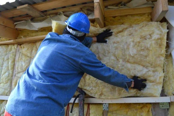 Builder  insulating wooden house with mineral  wool — Stock Photo, Image