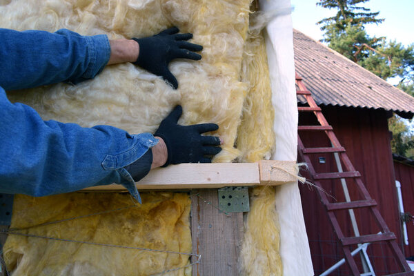 worker hands on house  insulatiom material rockwool