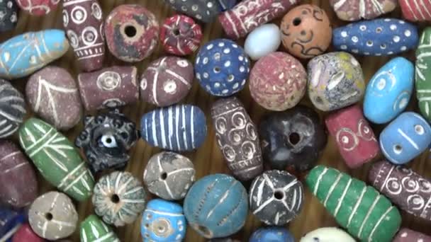 Rotating ancient vintage colorful decorated ceramic indian beads from Varanasi — Stock Video